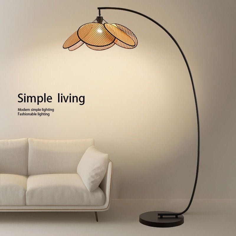 Wicker floor lamp with fishing design, perfect for living room, stylish and decorative, ideal for use next to a sofa.