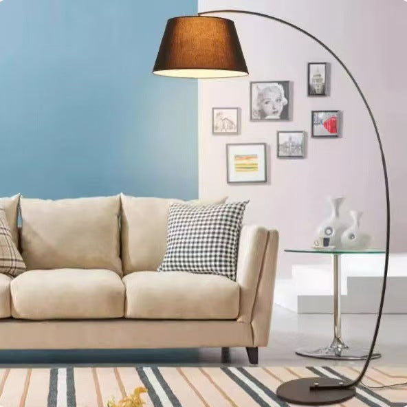 Wicker floor lamp with fishing design, perfect for living room, stylish and decorative, ideal for use next to a sofa.